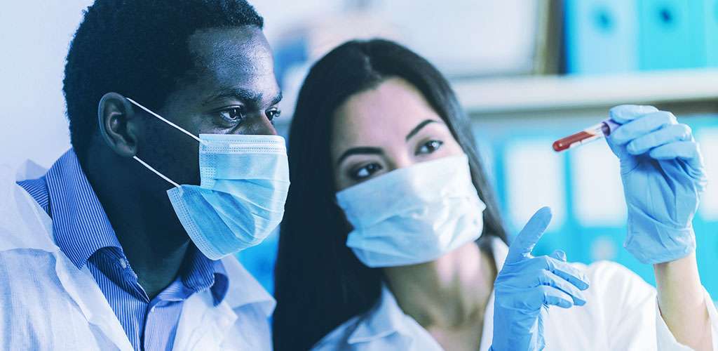 Two pharmacists testing in a laboratory.