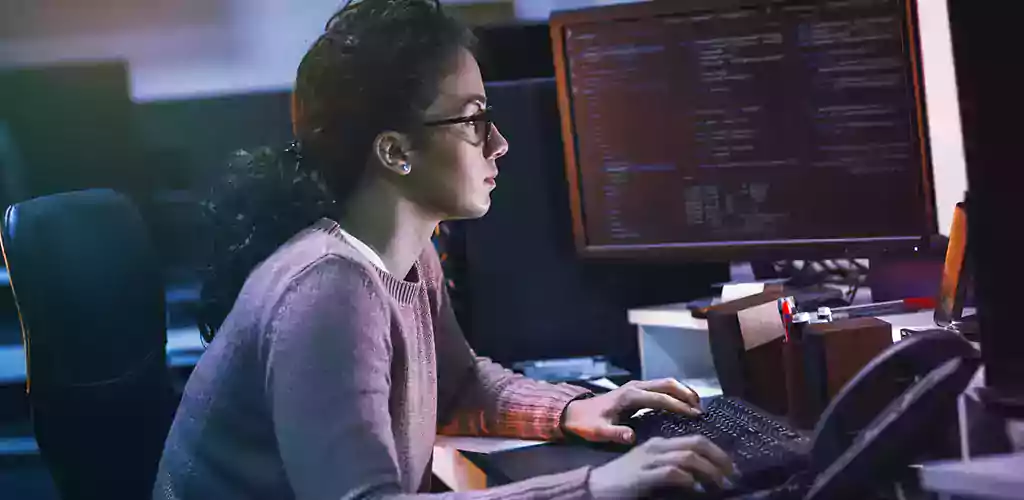 A woman in front of her computer working in her office.