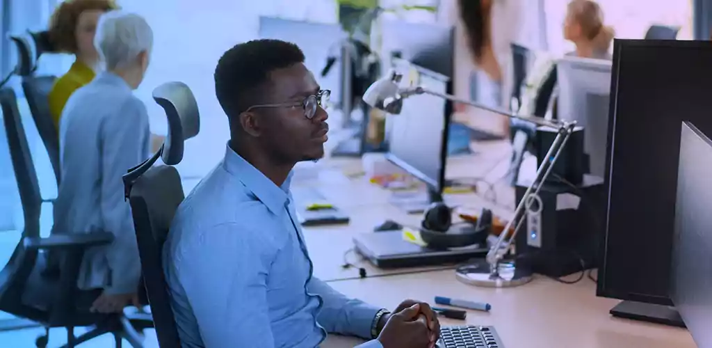 Man working on double monitors 