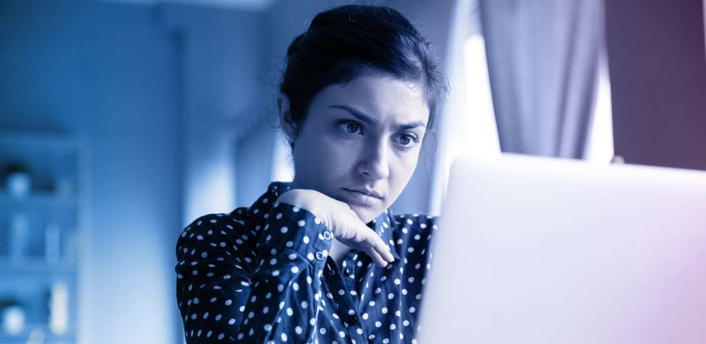 A woman in front of her computer.