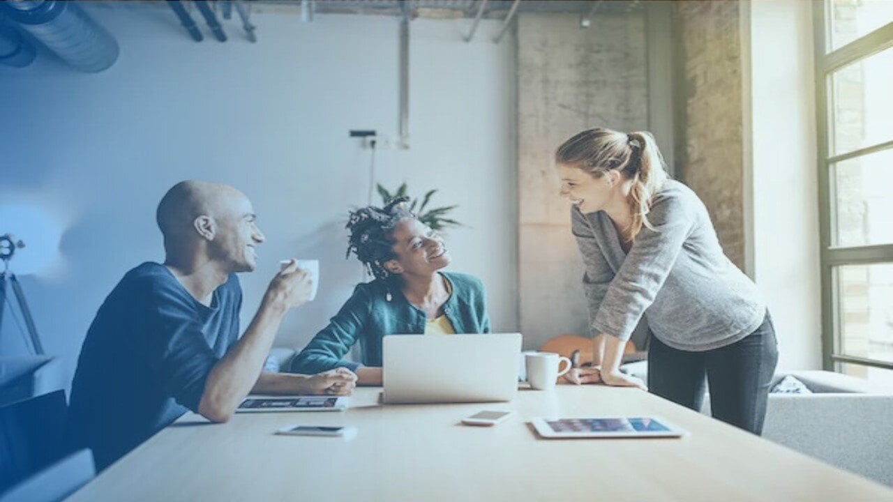 A group of people around an office.